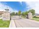 Secured community entrance features automatic gate, stone pillars and manicured landscaping at 4405 Fairway Ln, Broomfield, CO 80023