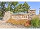 Stone community sign for Broadlands community featuring colorful landscaping, flowering plants and established trees at 4405 Fairway Ln, Broomfield, CO 80023