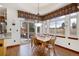 Bright dining area features hardwood floors, large windows, stylish lighting, and sliding glass doors to the outdoor patio at 4405 Fairway Ln, Broomfield, CO 80023