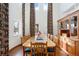 Spacious dining room with tall ceilings, large windows, beautiful drapes, hardwood floors, and a wooden hutch at 4405 Fairway Ln, Broomfield, CO 80023