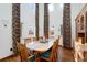Open dining room features tall ceilings, large windows with elegant drapes, hardwood floors, and a wooden hutch at 4405 Fairway Ln, Broomfield, CO 80023