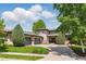 Stunning exterior showcasing a modern home with manicured lawn, mature trees, and a spacious driveway at 4405 Fairway Ln, Broomfield, CO 80023