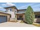 Close up of a home exterior highlighting a stone facade, large windows, and a well-maintained front yard at 4405 Fairway Ln, Broomfield, CO 80023