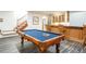 Basement featuring a pool table, bar area, and stairs to the upper level at 4405 Fairway Ln, Broomfield, CO 80023
