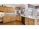 Bright kitchen featuring wood cabinets, granite countertops, and modern appliances at 4405 Fairway Ln, Broomfield, CO 80023