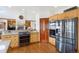 Well-appointed kitchen showcasing stainless steel appliances, wood floors, and granite countertops at 4405 Fairway Ln, Broomfield, CO 80023