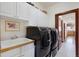 Convenient laundry room with modern washer/dryer, sink, and ample storage cabinets at 4405 Fairway Ln, Broomfield, CO 80023
