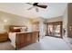 Comfortable main bedroom with plush carpeting, a ceiling fan, and access to an outdoor patio and fireplace at 4405 Fairway Ln, Broomfield, CO 80023