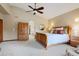Spacious main bedroom features plush carpeting, a ceiling fan, and an arched entrance to an en-suite bathroom at 4405 Fairway Ln, Broomfield, CO 80023