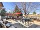 Inviting backyard patio with comfortable seating and a charming red umbrella, ideal for outdoor gatherings and relaxing at 4405 Fairway Ln, Broomfield, CO 80023