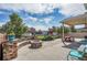 Large backyard with a covered patio, a fire pit, and a picnic table at 4996 Cathay Ct, Denver, CO 80249