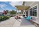 A covered patio features comfortable seating, perfect for relaxing in the backyard at 4996 Cathay Ct, Denver, CO 80249
