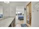Bright bathroom featuring granite countertops, a sink, and a shower at 4996 Cathay Ct, Denver, CO 80249