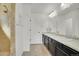 Bathroom featuring double sinks, updated fixtures, and a walk-in shower at 4996 Cathay Ct, Denver, CO 80249