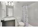 Bathroom with a sink, toilet, shower and a patterned shower curtain at 4996 Cathay Ct, Denver, CO 80249