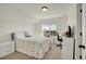 Bright bedroom featuring a window view and neutral decor at 4996 Cathay Ct, Denver, CO 80249