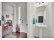 A view of the foyer with entry door, flowing into a playroom; a half bathroom on the right at 4996 Cathay Ct, Denver, CO 80249
