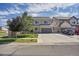 Charming two-story home boasts a well-maintained lawn, a spacious driveway, and an attached two-car garage at 4996 Cathay Ct, Denver, CO 80249