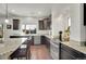 Well-lit kitchen with granite countertops, stainless steel appliances, and dark wood cabinets at 4996 Cathay Ct, Denver, CO 80249
