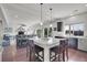 Modern kitchen featuring a large island, granite countertops, wood floors, and stainless steel appliances at 4996 Cathay Ct, Denver, CO 80249
