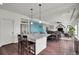 Kitchen with an island and open floor plan to a dining and living space at 4996 Cathay Ct, Denver, CO 80249