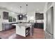 Spacious kitchen featuring a large island, stainless appliances, and dark cabinets at 4996 Cathay Ct, Denver, CO 80249