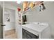 Bright laundry room featuring a front loading washer/dryer set and storage shelving at 4996 Cathay Ct, Denver, CO 80249