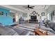 Cozy living room with a ceiling fan, large couches, and modern décor at 4996 Cathay Ct, Denver, CO 80249