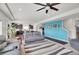 Open living room and kitchen layout with a blue accent wall and dark wood floors at 4996 Cathay Ct, Denver, CO 80249