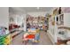 Open playroom features carpeted floors and a view to foyer and the living room at 4996 Cathay Ct, Denver, CO 80249