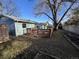 This backyard showcases a wooden deck for outdoor gatherings and a large mature tree for shade at 2741 W 134Th Cir, Broomfield, CO 80020