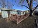 A wooden deck is attached to the home and creates a place to relax with outdoor seating and a large tree at 2741 W 134Th Cir, Broomfield, CO 80020