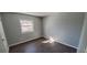 This bedroom has gray walls, brown floors, and a window that lets in natural light at 2741 W 134Th Cir, Broomfield, CO 80020