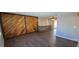 Spacious living room featuring wood-look flooring and a custom wood accent wall at 2741 W 134Th Cir, Broomfield, CO 80020
