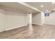 Finished basement boasts wood-look floors and ample lighting, creating a versatile space for recreation or relaxation at 5645 S Himalaya Way, Centennial, CO 80015