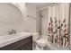 A modern bathroom featuring a vanity with storage, shower, and decorative floral curtains at 5645 S Himalaya Way, Centennial, CO 80015