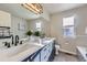 Bright bathroom featuring double sinks with modern fixtures and a large vanity at 5645 S Himalaya Way, Centennial, CO 80015