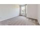 A minimal bedroom with neutral carpet, a window with light curtains, and soft natural light at 5645 S Himalaya Way, Centennial, CO 80015