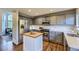 Spacious kitchen featuring stainless steel appliances, gray cabinetry, and a butcher block island at 5645 S Himalaya Way, Centennial, CO 80015