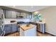 Well-lit kitchen with grey cabinets, stainless steel appliances, and butcher block island at 5645 S Himalaya Way, Centennial, CO 80015