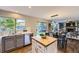 Open kitchen featuring stainless steel appliances and seamless transition to dining and living area at 5645 S Himalaya Way, Centennial, CO 80015