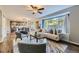 Bright living room featuring hardwood floors, neutral tones, and a large window with natural light at 5645 S Himalaya Way, Centennial, CO 80015