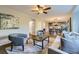 An open-concept living room shows the hardwood floors, modern furnishings, and seamless connection to the kitchen at 5645 S Himalaya Way, Centennial, CO 80015