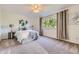 A tranquil main bedroom offers soft carpet, neutral walls, and a large window with green tree views at 5645 S Himalaya Way, Centennial, CO 80015