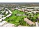 Expansive aerial view of a community with a golf course, ponds, mature trees, and residential buildings at 695 S Alton Way # 9C, Denver, CO 80247