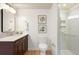 Modern bathroom with granite vanity, updated fixtures, and glass-enclosed shower at 695 S Alton Way # 9C, Denver, CO 80247
