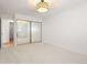 Bedroom featuring an open door and a closet with full mirrored sliding doors at 695 S Alton Way # 9C, Denver, CO 80247