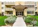 Inviting entrance to building with manicured landscaping and a covered walkway at 695 S Alton Way # 9C, Denver, CO 80247