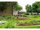 Relaxing garden area with a multi-tiered fountain, seating, and lush landscaping at 695 S Alton Way # 9C, Denver, CO 80247