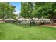 Exterior common area featuring seating, lawn, and mature shade trees at 695 S Alton Way # 9C, Denver, CO 80247